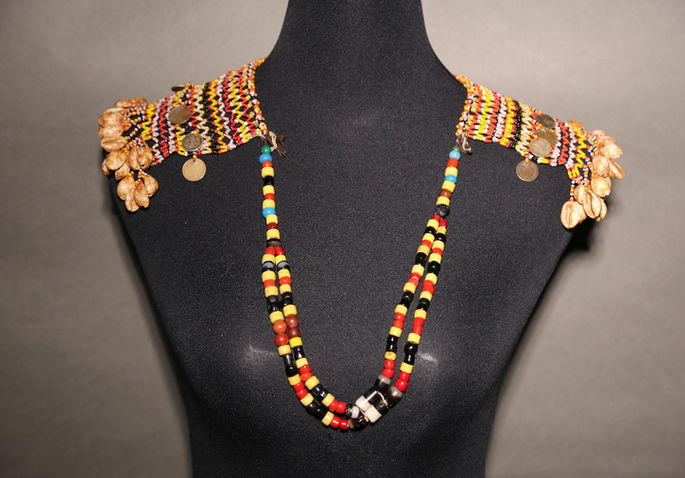 A front view shot of the karawaweng showing the beadwork of the necklace’s strap