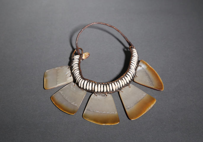 A shell ornament for neck made with fine basket work on the lace and intricately arranged and carved shell embellishments