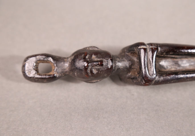 A detailed shot that shows the face and headdress of the anthropomorphic figurine