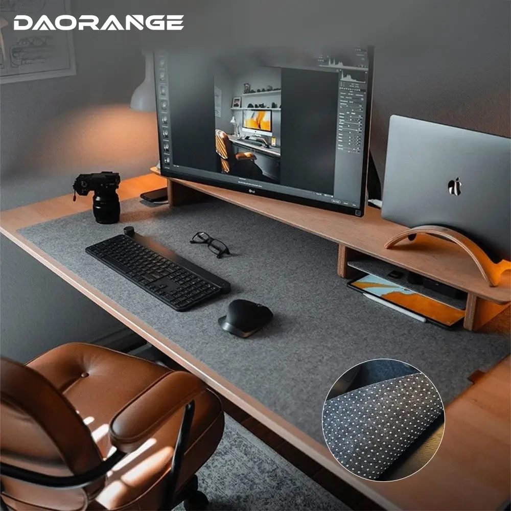 Wool felt desk mat covering a desk with keyboard and monitor