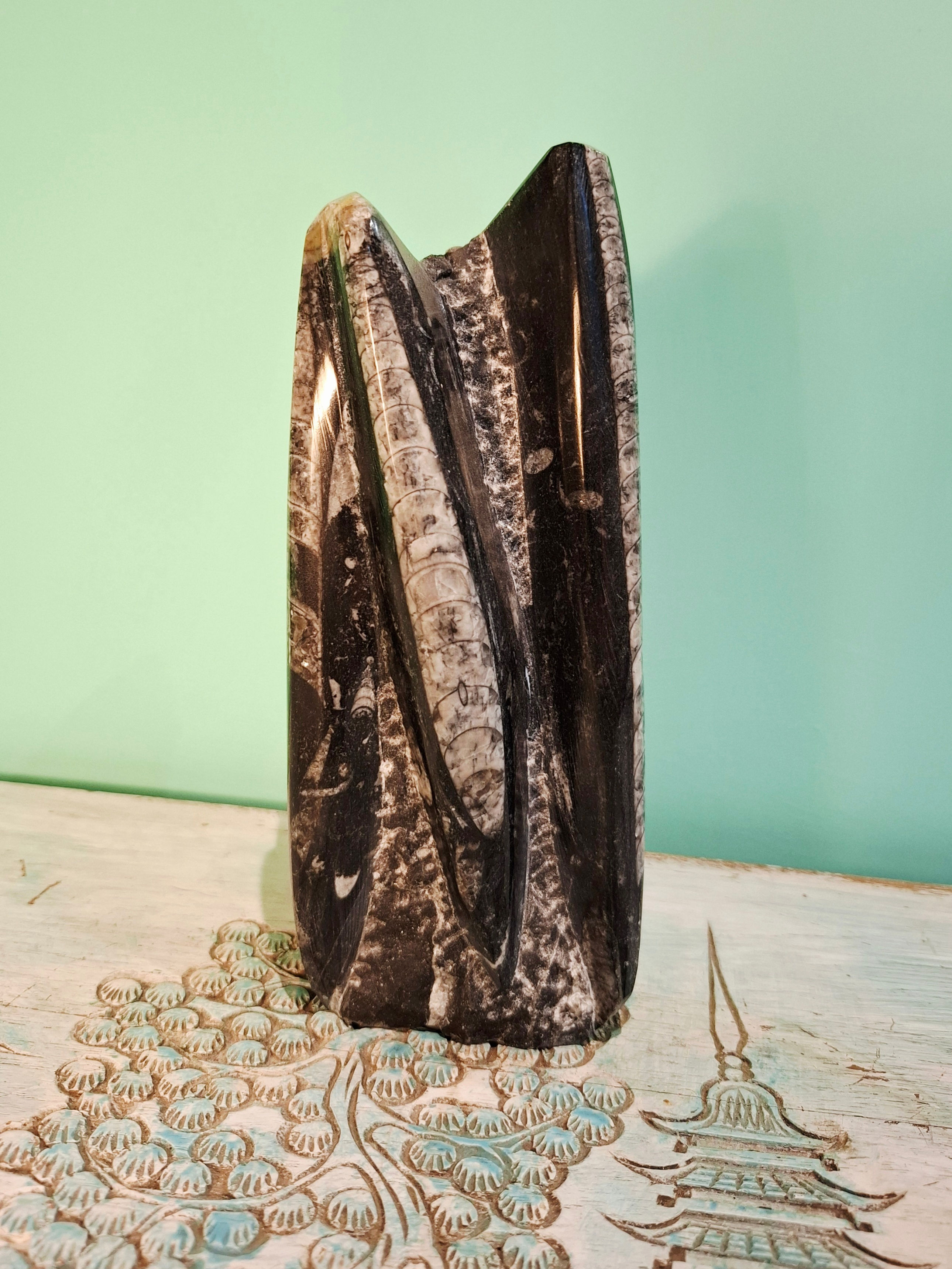 Heavy fossil stone sculpture with visible orthoceras fossils