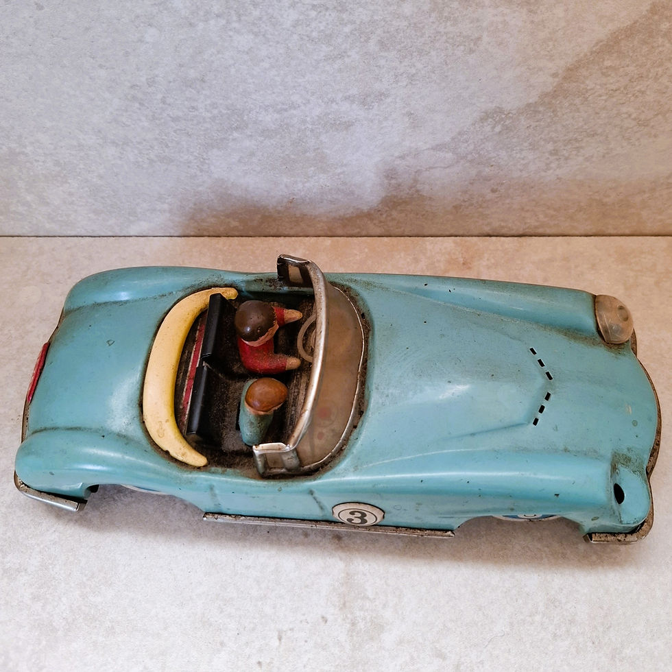 Thumbnail: Vintage MF763 tinplate racing car showing wooden driver figures