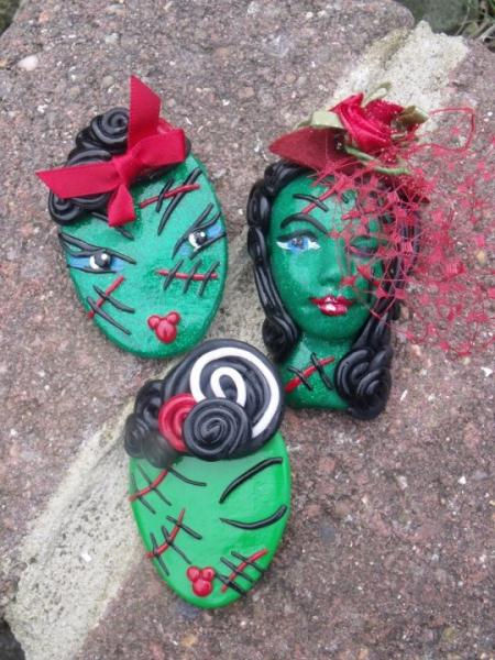 Set of three Frankenstein-style brooches featuring green glitter faces, stitched scar details, vintage hair styles, and red a