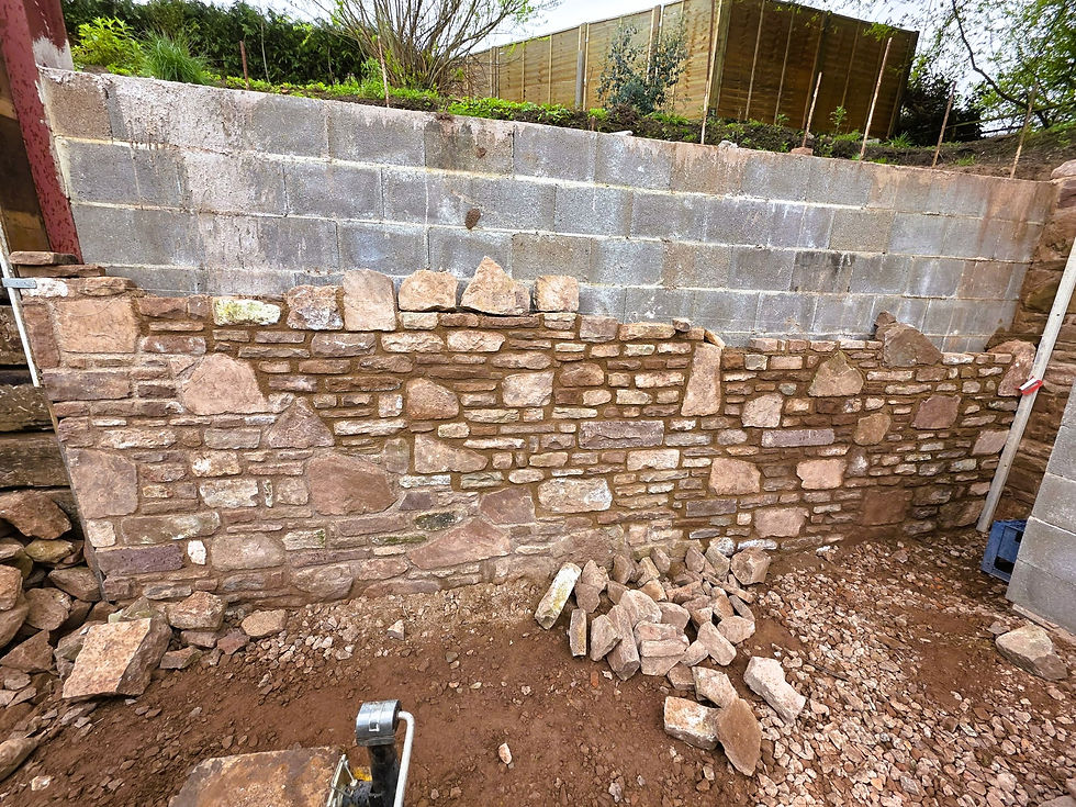 Thumbnail: Reclaimed red sandstone used to create a traditional stone retaining wall.