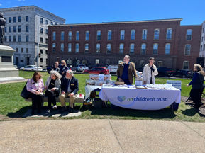 Representatives from over 20 partner organizations stand together at the Community Commitment to Family Well-Being Event, united in their commitment to strengthening New Hampshire families.