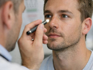 Doctor performing a pupillary light reflex examination using a pen torch during a clinical assessment, illustrating high-yield neurology concepts for MSRA preparation.