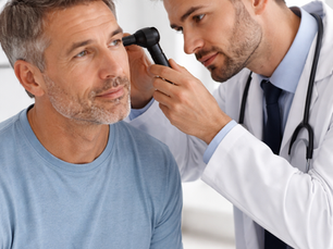 Doctor examining a patient’s ear with an otoscope in a clinic setting, demonstrating ear examination skills for PLAB 2, focusing on diagnosing otitis externa, otitis media, and identifying red flag features.
