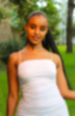 Portrait of woman with ponytail hairstyle staring into the camera, smiling