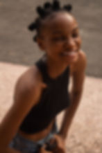 Black woman wearing bantu knots and smiling