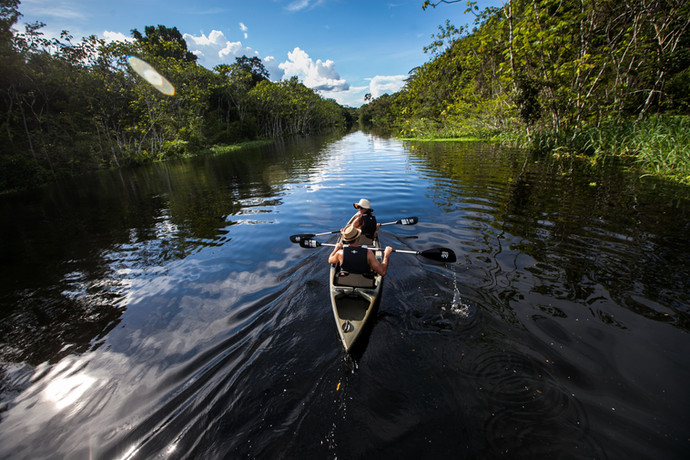 Guests canoeing in the Peruvian Amazon with Delfin Amazon Cruises