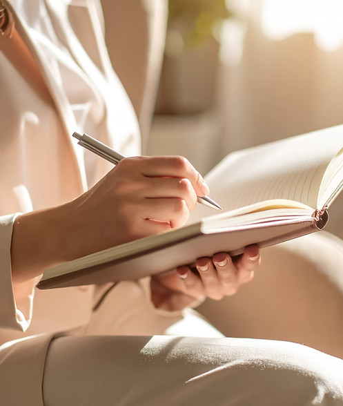 Reimagine Education therapist writing in a notebook