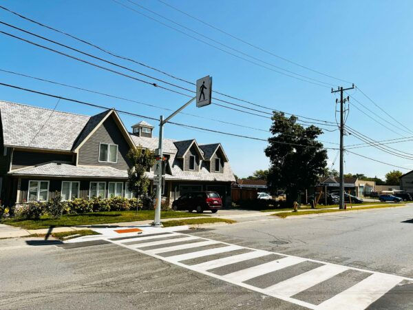 Full view of pedestrian crosswalk with RRFB beacons and signage at Jacob Beam Public School in Beamsville.