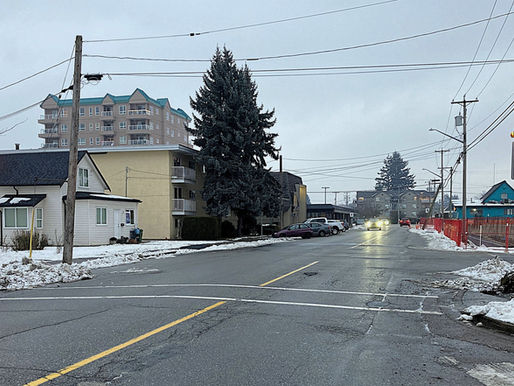 A new Rectangular Rapid Flashing Beacon (RRFB) has been installed at the intersection of Parkland Drive and McKenzie Avenue, enhancing pedestrian safety in this snowy neighborhood setting.