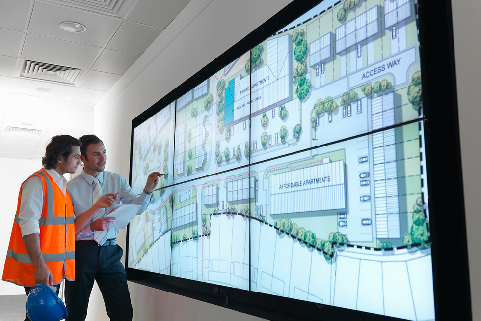 City planners examine comprehensive architectural designs on a large screen