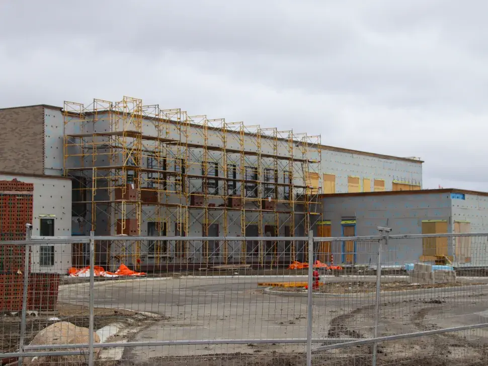 Ongoing construction work at Parkhill School as scaffolding and fencing outline the new building's progress.