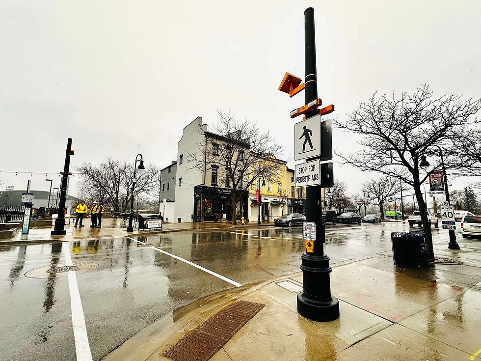 A city street features a Rectangular Rapid Flashing Beacon (RRFB) to enhance pedestrian safety in Niagara Region Ontario
