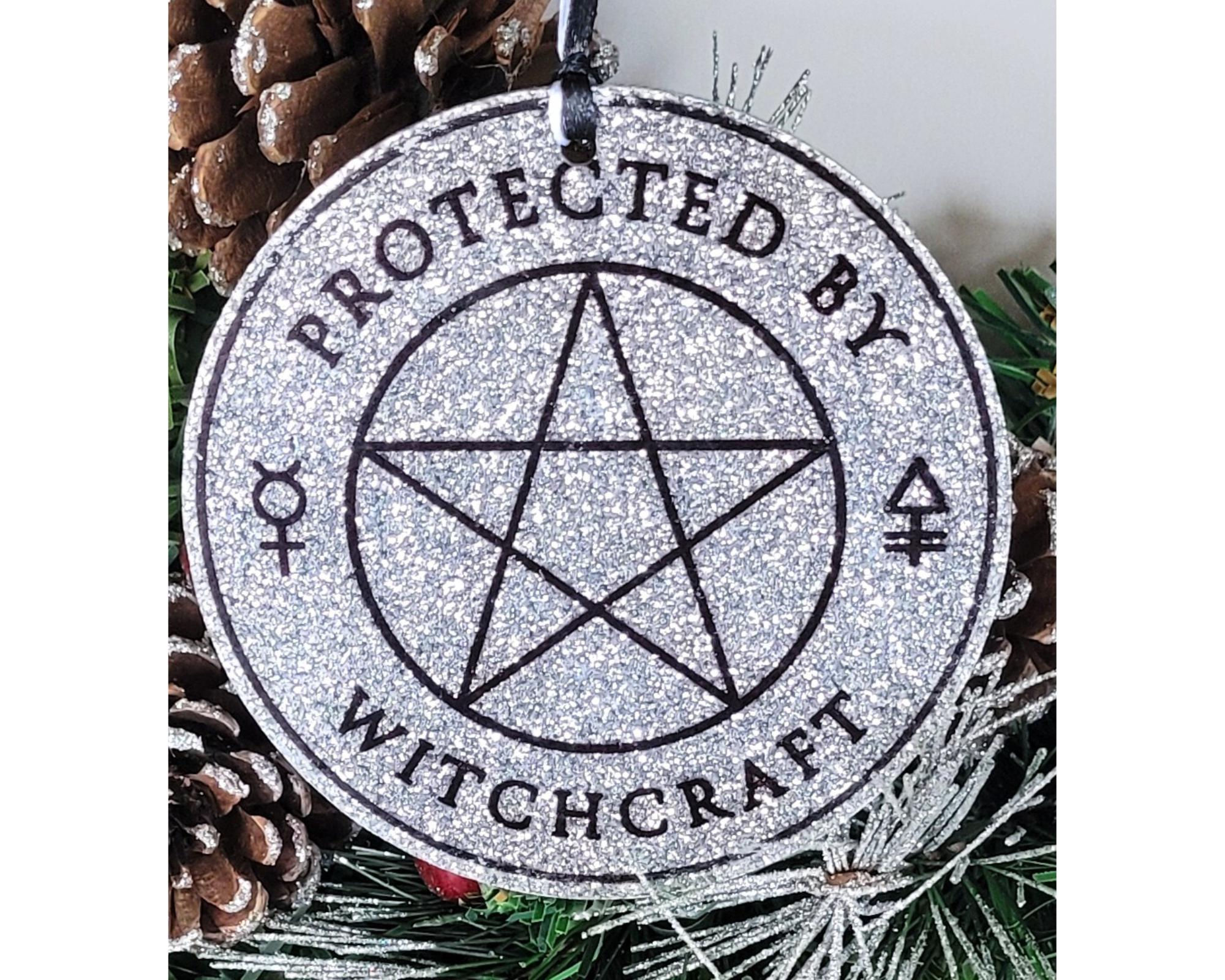 silver acrylic ornament with pentagram and “protected by witchcraft” text, gothic witchy hanging decoration