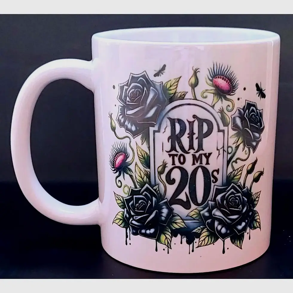 White ceramic gothic mug with black rose and tombstone design reading “RIP to my 20s,” surrounded by vines and dark florals.