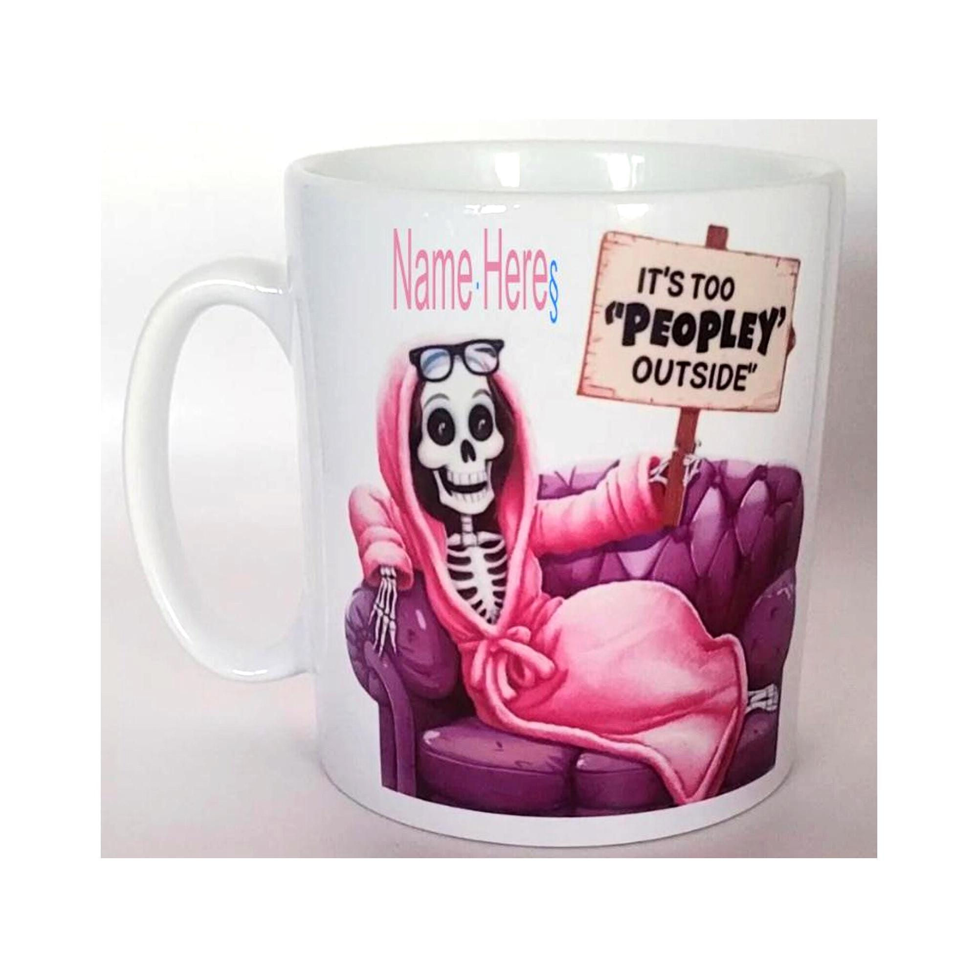 Funny gothic mug with skeleton in pink robe holding sign that says "It’s Too Peopley Outside"