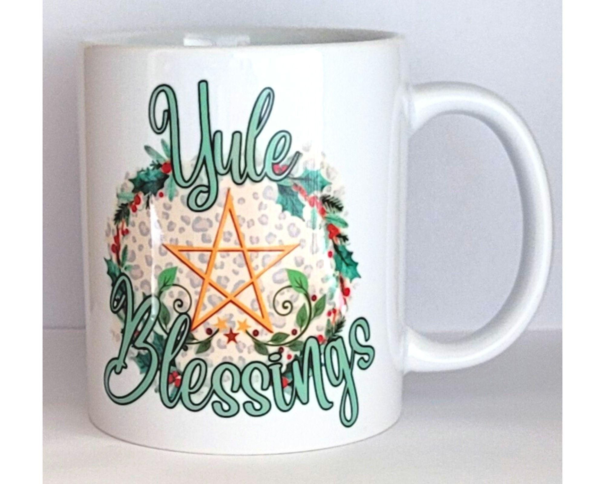 white ceramic Yule mug with pentacle and holly wreath design – pagan winter solstice coffee cup