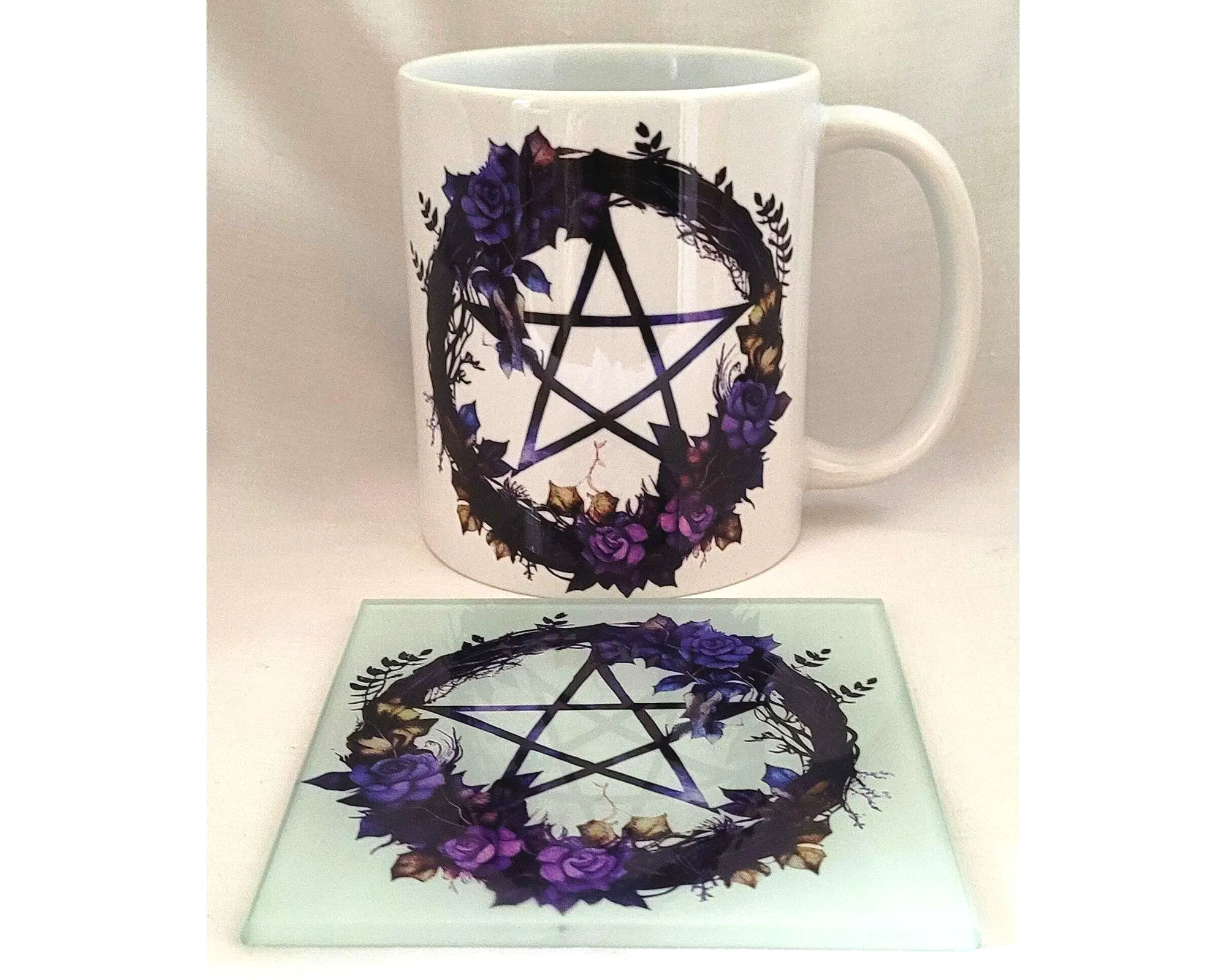 white ceramic pentacle mug with purple rose design and glass coaster