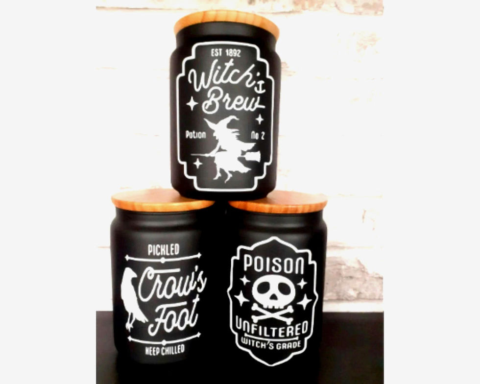 Set of black glass witchy storage jars with gothic labels Witch’s Brew, Poison, and Pickled Crow’s Foot.