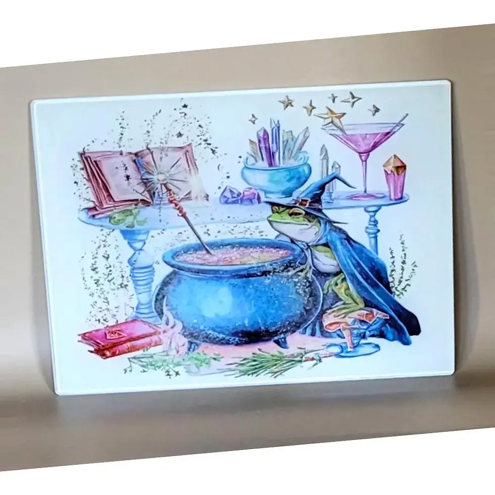 witchy frog glass chopping board with cauldron, books, crystals and potion scene