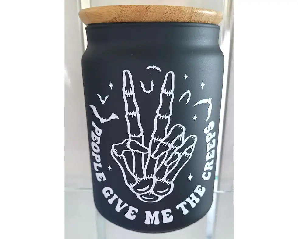 Gothic black glass storage jar with bamboo lid and white skeleton hand design reading “People Give Me The Creeps.”