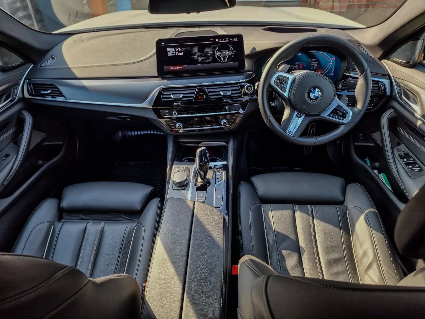 BMW 5 Series interior: black leather seats, infotainment screen