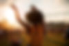 Young African American woman dancing at summer holi festival, back view.jpg