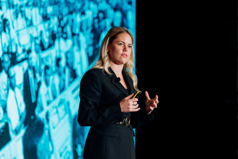 female keynote speaker presenting at corporate business conference