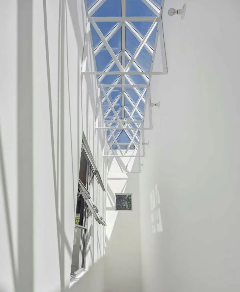 A steepled skylight floods sunshine down the stairway at 80 Wilmot.