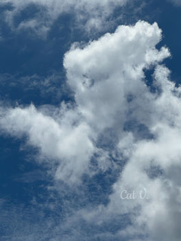 Towering white clouds rising into a deep blue sky, symbolizing dreams, limitless possibilities, hope, inspiration, and personal growth.