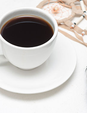 White tea cup with black coffee, dreamca