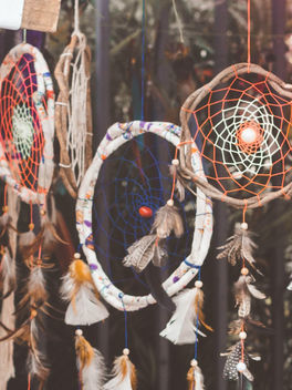 Colorful dreamcatchers hanging outdoors representing ancient dream traditions, spiritual symbolism, and dream interpretation.