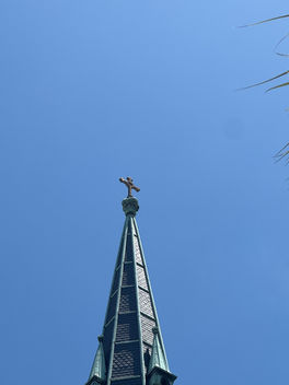cathedral steeple reaching into a clear blue sky, symbolizing spiritual guidance, hope, faith, and higher perspective.