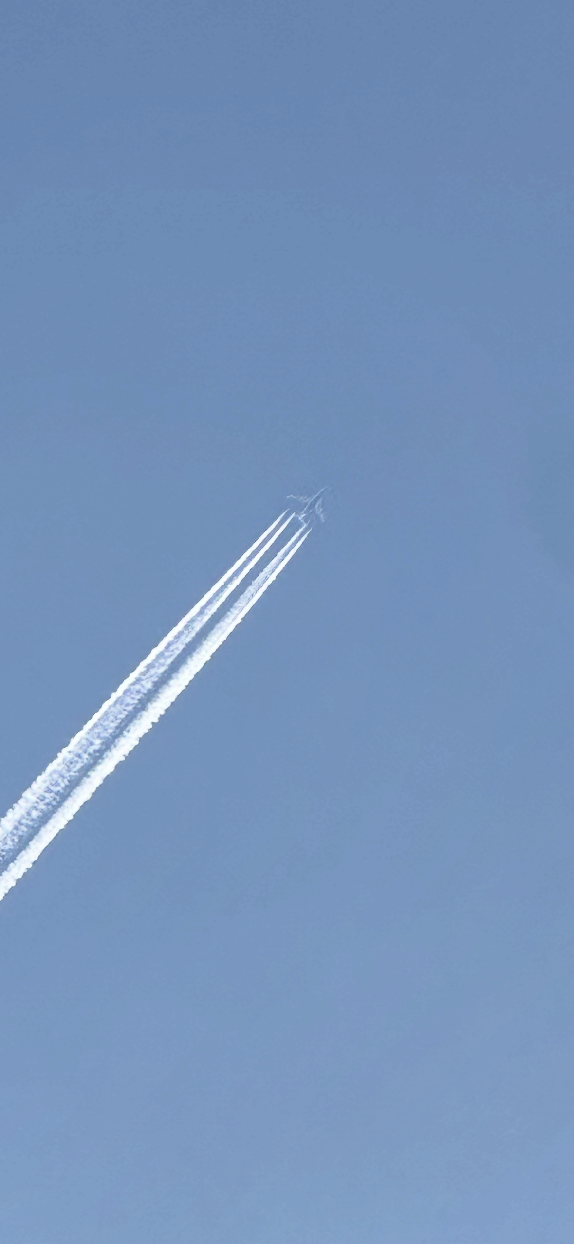Jet contrails crossing a blue sky, representing growth, progress, and the Build Momentum website package for small businesses.