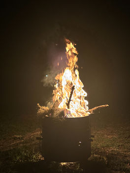 Bonfire blazing against a dark night sky, symbolizing the Fire element in astrology and the energetic influence of zodiac elements on personality and growth.