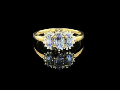 Yellow gold tanzanite trilogy ring