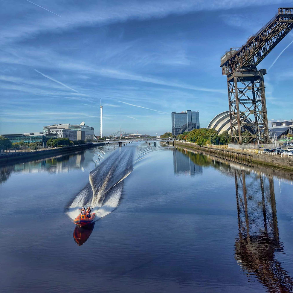 Boat cruising down the river clyde passing by iconic glasgow landmarks