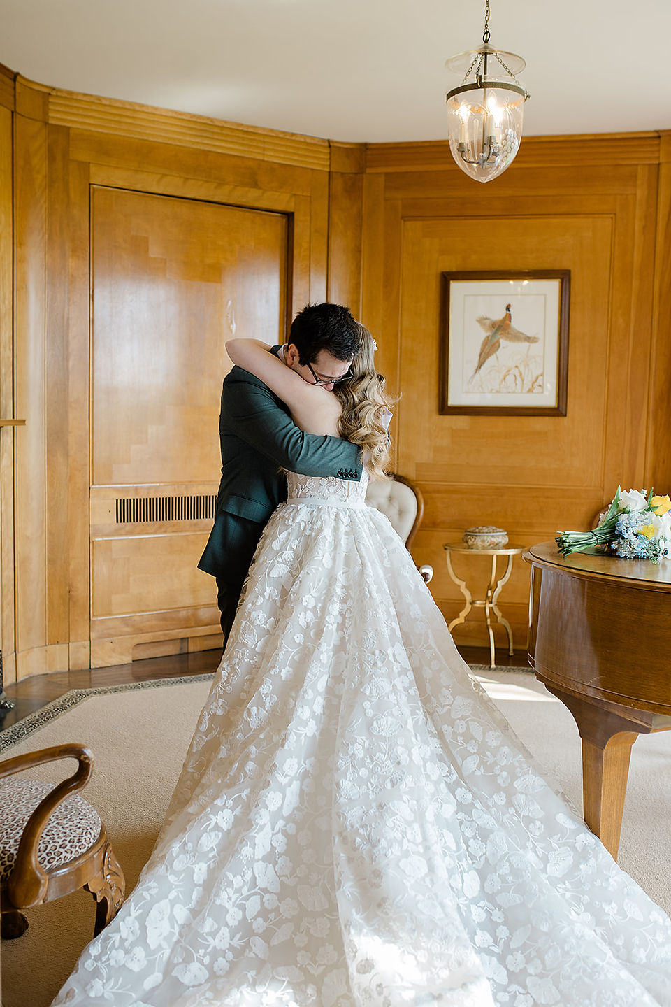 A bride and groom hugging in a wooden room