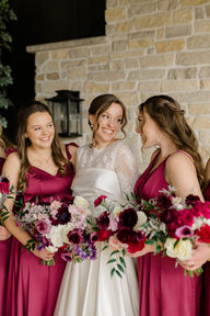A bride laughing with her bridesmaids