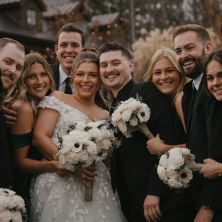 Bride and Groom Smiling with Bridal Party
