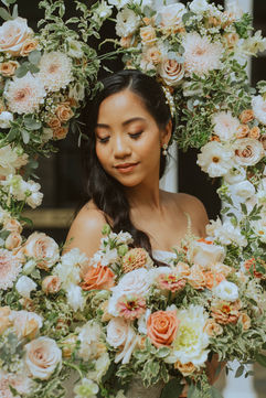 A bride surrounded by bushels of flowers