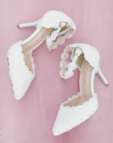 A pair of white heels