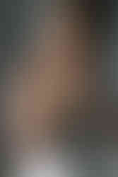 A bride putting earrings on