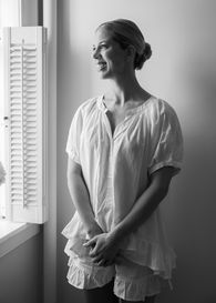 A bride smiling out the window
