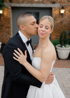 A groom kissing his bride's cheek