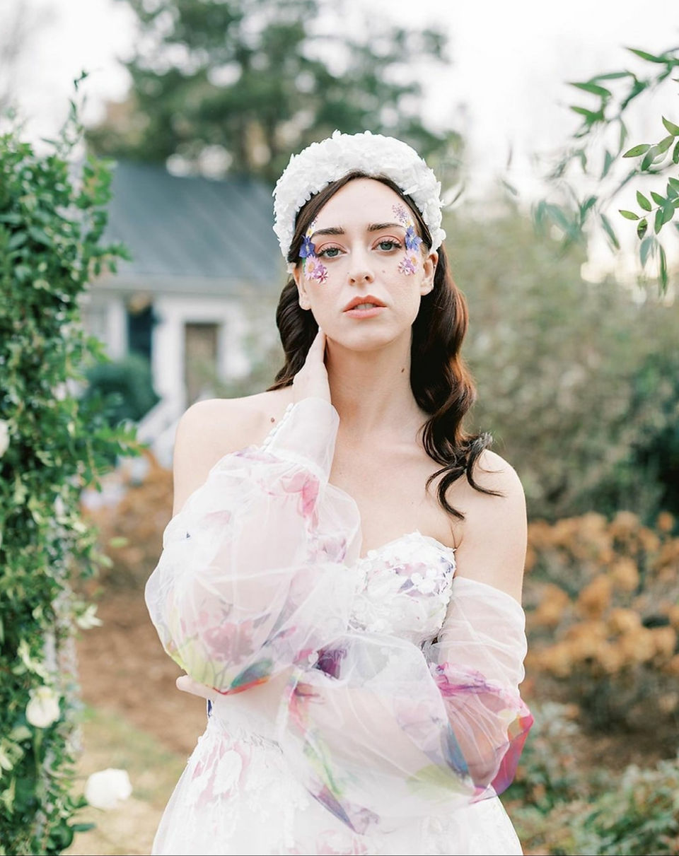 A bride with a floral wedding dress outside
