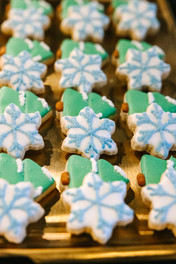 A platter of snowflake and christmas tree cookies